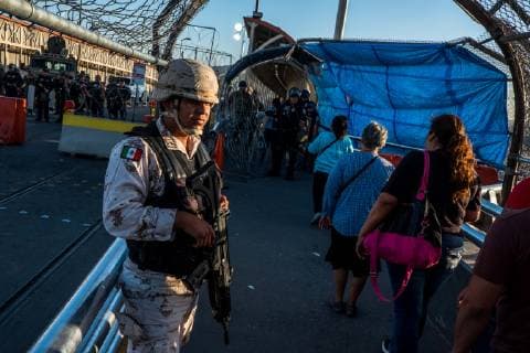 July 1, 2019 - Ciudad Juarez, Chihuahua, MEX - A Mexican military troop stands nearby the international boundary on the Paso del Norte Bridge as U.S. Customs and Border Protection and Border Patrol agents occupied the space blocking traffic from coming into the United States to El Paso, Texas, after protests in the early morning took place in Ciudad Juarez, Chihuahua, Mexico. Agents began letting pedestrians to cross by checking identification one person at a time once the protests subsided. Ciudad Juarez MEX - ZUMAj106 20190701_zap_j106_018 Copyright: xJoelxAngelxJuarezx