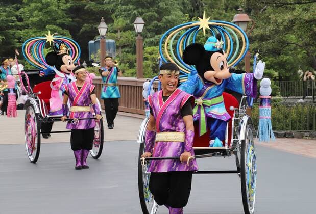 July 2, 2019, Urayasu, Japan - Disney characters Mickey (R) and Minnie Mouse (L) dressed in Tanabata or the Star Festival costumes wave from rickshaws as they greet guests along the parade route at the Tokyo Disneyland in Urayasu, suburban Tokyo on Tuesday, July 2, 2019. In Japanese legend the two lovers Altair and Vega, who are separated by the Milky Way on most days of the year, meet just once a year on July 7.  (107145829)