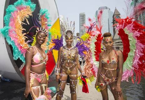 (190709) -- TORONTO, July 9, 2019 -- Dressed-up revelers pose for photos during the official launch ceremony of the 2019 Toronto Caribbean Carnival in Toronto, Canada, July 9, 2019. The annual four-week cultural festival of Caribbean music, cuisine and revelry kicked off on Tuesday. King and Queen costume competition, Junior Carnival, Grand Parade and other events will be held during the festival. ) CANADA-TORONTO-CARIBBEAN CARNIVAL-LAUNCH CEREMONY ZouxZheng 