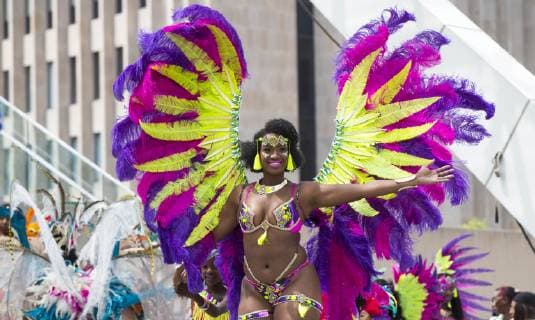 (190709) -- TORONTO, July 9, 2019 -- A dressed-up reveler performs during the official launch ceremony of the 2019 Toronto Caribbean Carnival in Toronto, Canada, July 9, 2019. The annual four-week cultural festival of Caribbean music, cuisine and revelry kicked off on Tuesday. King and Queen costume competition, Junior Carnival, Grand Parade and other events will be held during the festival. ) CANADA-TORONTO-CARIBBEAN CARNIVAL-LAUNCH CEREMONY ZouxZheng 
