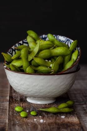 Small bowl with fresh green Edamame with coarse salt Green soy beans with salt Small bowl with fresh green Edamame with coarse salt Green soy beans with salt  1079705743