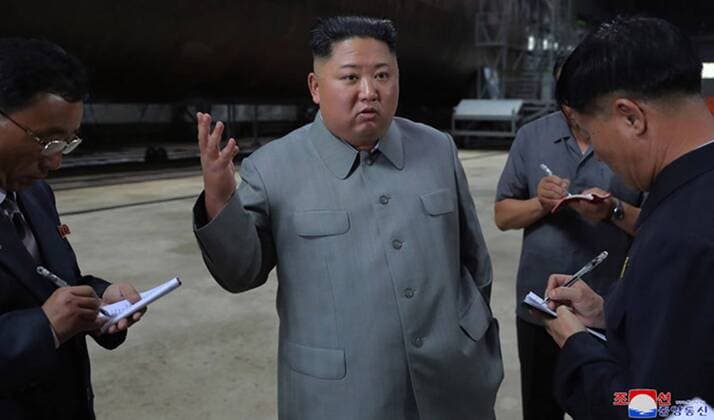 This image, released on July 23, 2019, by the North Korean Official News Service (KCNA), shows North Korean leader Kim Jong Un inspecting a newly built submarine. Kim, who expressed great satisfaction over the fact that the submarine was designed and built to be capable of fully implementing the military-strategic intention, learned in detail about its operational and tactical data and combat weapon systems.  WAX2019072401 KCNA