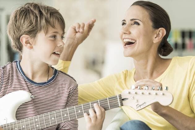 mother and son make music together, mother sings and son plays E guitar, laugh, portrait, Germany, Europe Copyright: imageBROKER/m3 ibxres04671297.jpg