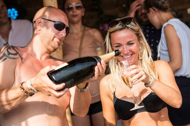 people are drinking champagne at the first day of the second weekend of the Tomorrowland music festival, Friday 26 July 2019. The 15th edition of Tomorrowland electronic music festival takes place at the De Schorre terrain in Boom from 19 to 21 July 2019 and from 26 to 28 July 2019.  DAVIDxPINTENS 05633896