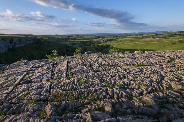 Evening light shows dramatic surface of the famous Limestone Pavement at Malham Cove in the Yorkshire Dales National Park, Yorkshire, England, United Kingdom, Europe Copyright: AlexxTreadway 1225-1312