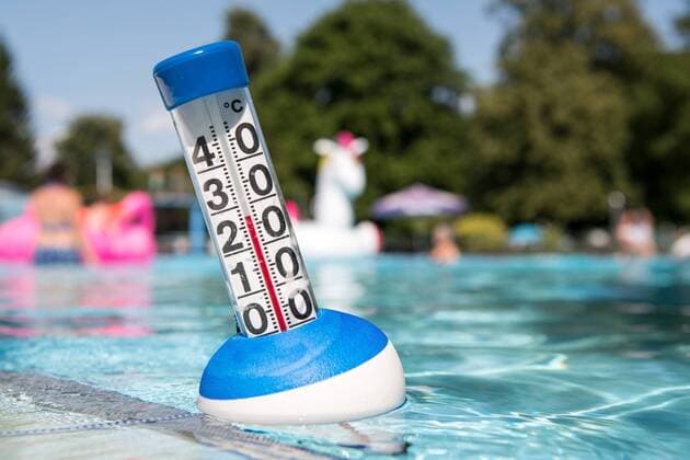 Midsummer a thermometer shows a water temperature of 27 degrees Celsius on 27 July 2019 in an outdoor pool in Germany