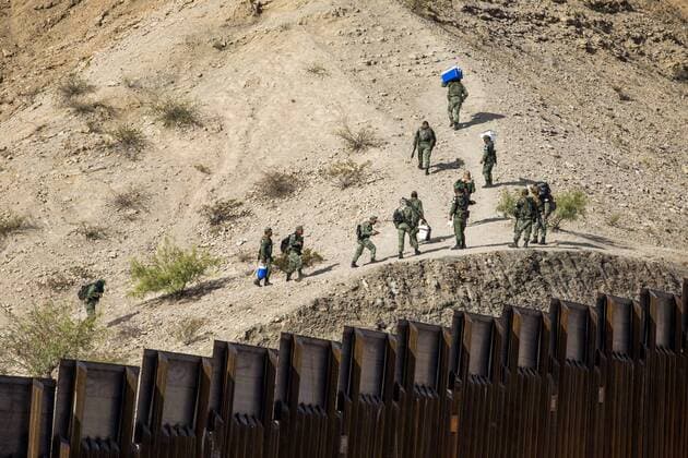 July 27, 2019, Sunland Park, New Mexico, USA: Mexican military is seen walking up a mountainside nearby a privately-funded fence along the U.S.-Mexico border during the Symposium at The Wall event in Sunland Park, New Mexico. Sunland Park USA - ZUMAj106 20190727_zap_j106_031 Copyright: xJoelxAngelxJuarezx