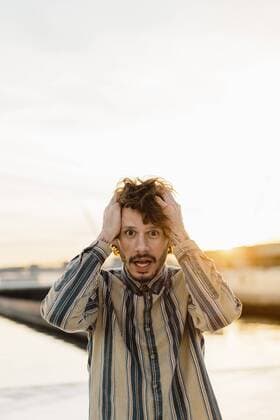Portrait of staring man with hands on his hand at sunset model released Symbolfoto  AFVF03354
