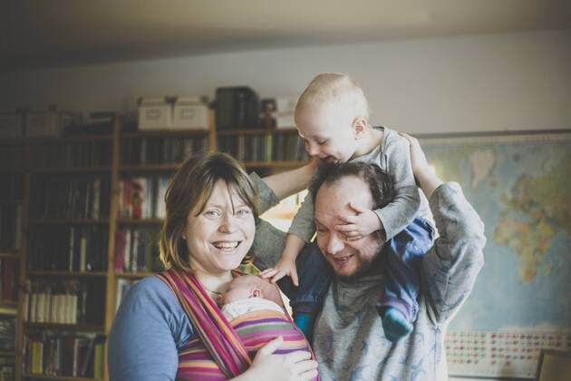 Portrait of happy family of four at home model released Symbolfoto property released  IHF00095
