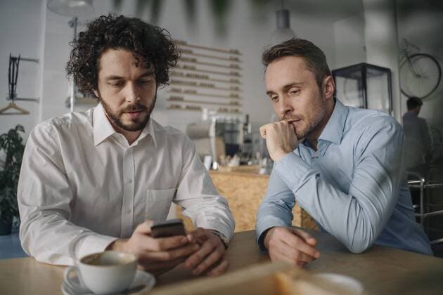 Two businessmen having a meeting in a coffee shop model released Symbolfoto property released  KNSF05973
