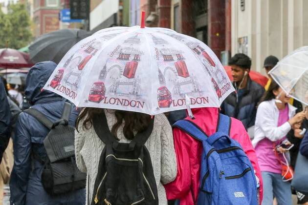 July 30, 2019, London, United Kingdom: A tourist shelters under a London designed umbrella in London as rain falls after recent warm weather. London United Kingdom - ZUMAs197 20190730_zab_s197_018 Copyright: xStevexTaylorx