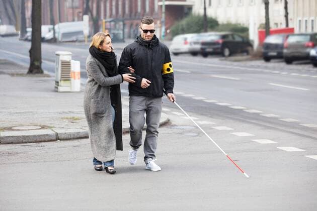 Woman Assisting Blind Man On Street ,model released, Symbolfoto  Copyright: xAndreyPopovx Panthermedia21371763