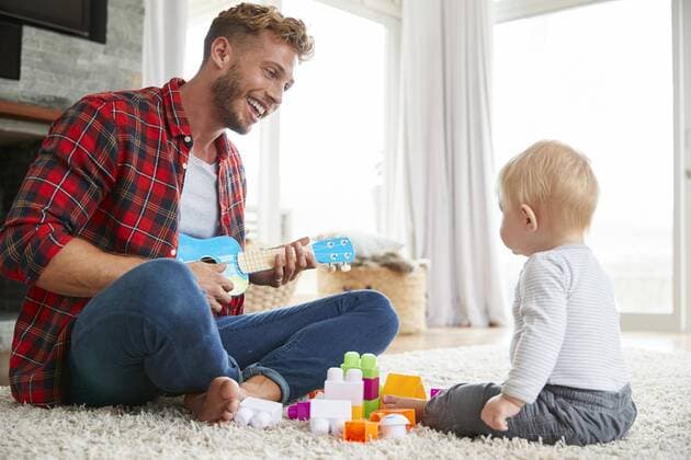  Father playing ukulele with young son at home, close up ,model released, Symbolfoto,property released  Copyright: xMonkeybusinessx Panthermedia25729102