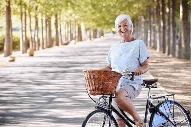  Portrait Of Smiling Senior Woman Cycling On Country Road ,model released, Symbolfoto,property released  Copyright: xMonkeybusinessx Panthermedia25729285
