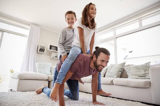  Father Giving Children Ride On Back In Lounge At Home ,model released, Symbolfoto,property released  Copyright: xMonkeybusinessx Panthermedia25730217