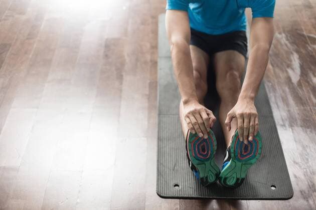  High-angle view of the hands of a man touching his toes as a stretching exercise ,model released, Symbolfoto  Copyright: xKzenonx Panthermedia25862080