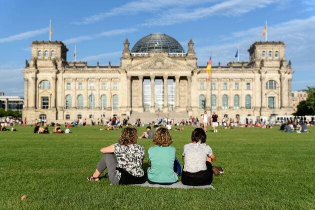 Three tourists on the recently released Reichstag meadow in front of the Berlin Reichstag snapshot photography F Boillot