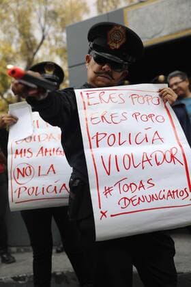 A woman dressed as a police agent holds a banner that reads You are poo poo rapist police during a protest held at the headquarters of the Public Security and Attorney General against sexual abuse committed by the Police in Mexico City, Mexico, 12 August 2019. Women protest against sexual abuse committed by Police !ACHTUNG: NUR REDAKTIONELLE NUTZUNG!  Copyright: xSashenkaxGutierrezx AME6527 20190813-637012827719652688