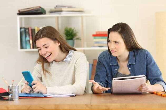  Angry student looking at her lazy mate ,model released, Symbolfoto  Copyright: xAntonioGuillemx Panthermedia26583708