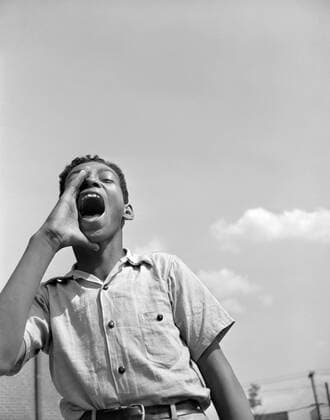 Teen Boy Shouting to Friends at Playground, Frederick Douglass Housing Project, Anacostia Neighborhood, Washington DC, USA, Photograph by Gordon Parks, June 1942  Copyright: xCircaxImagesx ghi-circa06920