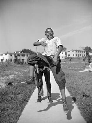 Two Boys Playing Leapfrog, Frederick Douglass Housing Project, Anacostia Neighborhood, Washington DC, USA, Photograph by Gordon Parks, July 1942  Copyright: xCircaxImagesx ghi-circa06922