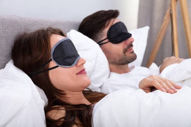  Couple Sleeping On Bed Using Eye Mask ,model released, Symbolfoto  Copyright: xAndreyPopovx Panthermedia26770758