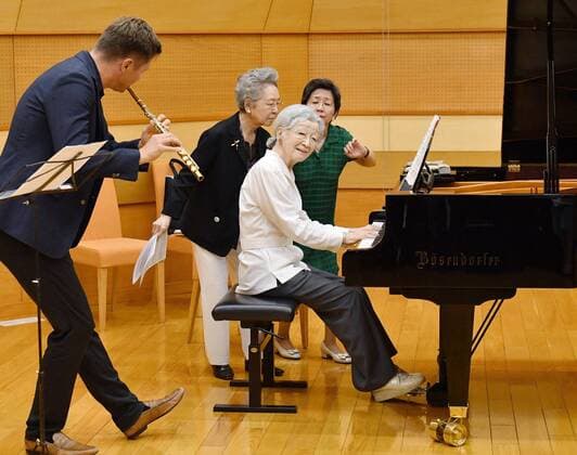 Former Japan empress at music workshop Former Japanese Empress Michiko plays the piano with flute player Karl-Heinz Schutz (L) during a music workshop in Kusatsu, Gunma Prefecture, eastern Japan, on Aug. 27, 2019.(Pool Photo) 