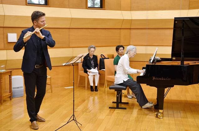 Former Japan empress at music workshop Former Japanese Empress Michiko plays the piano with flute player Karl-Heinz Schutz (L) during a music workshop in Kusatsu, Gunma Prefecture, eastern Japan, on Aug. 27, 2019. (Pool Photo) 