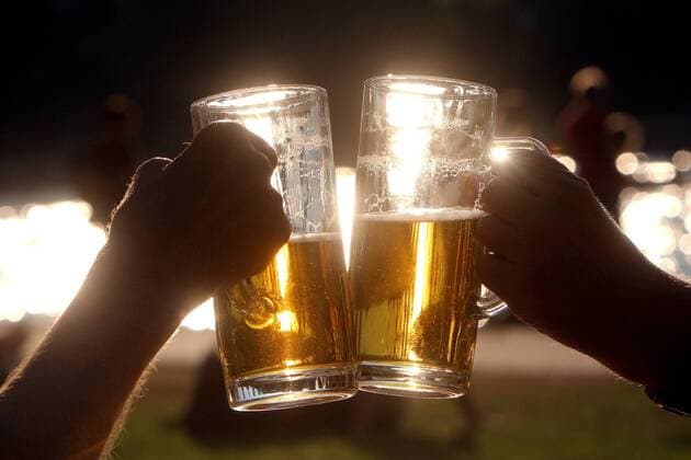 Joint frosting with beer glasses under the setting sun in backlight in Frankfurt, Hesse, Germany