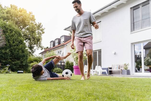 Father and son playing football in garden model released Symbolfoto property released  DIGF07795