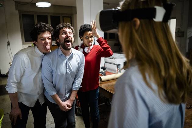IMAGO Creative, Lifestyle, Gaming Playful colleagues looking at woman wearing VR glasses in office model released Symbolfoto property released  GIOF06847