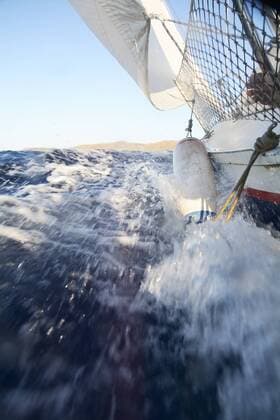 Sailing boat splashing water, Menorca, Spain model released Symbolfoto  IGGF01255