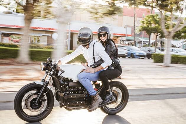 Couple riding motorbike in the city model released Symbolfoto property released  LJF00297