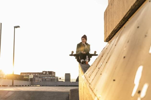 Stylish young woman with skateboard on parking deck model released Symbolfoto  UUF18336