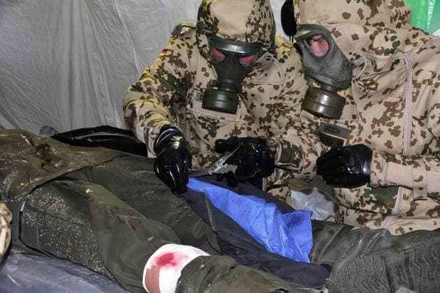 Bundeswehr soldiers in ABC protective suits treat a decontaminated patient during the Open Day of the Medical Regiment 2 in Rennerod in the Westerwald Rennerod Rhineland Palatinate Germany