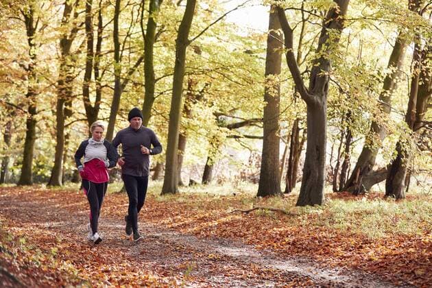  Mature Couple Running Through Autumn Woodland Together,model released, Symbolfoto  Copyright: xMonkeybusinessx Panthermedia25115544