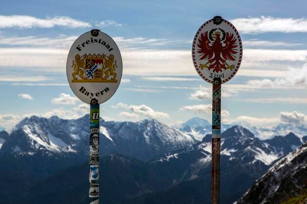 Border signs on the border between Germany and Austria on a ridge in the Karwendelgebirge near the mountain station of the Karwendelbahn border between Germany and Austria.