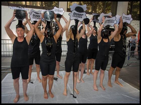 . 13 09 2019. London, United Kingdom. PETA Leather protest at London Fashion Week. PETA supporters pour buckets of black toxic slime over their heads at London Fashion Week to draw attention to the hazardous waste associated with the leather industry. Signs on the buckets read, Leather Is a Dirty Business and Dump Leather .  xMartynxWheatleyx xi-Imagesx IIM-20145-0002