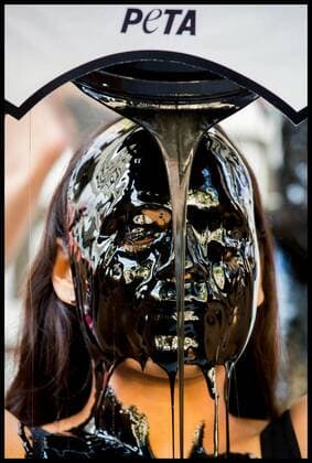 . 13 09 2019. London, United Kingdom. PETA Leather protest at London Fashion Week. PETA supporters pour buckets of black toxic slime over their heads at London Fashion Week to draw attention to the hazardous waste associated with the leather industry. Signs on the buckets read, Leather Is a Dirty Business and Dump Leather .  xMartynxWheatleyx xi-Imagesx IIM-20145-0005