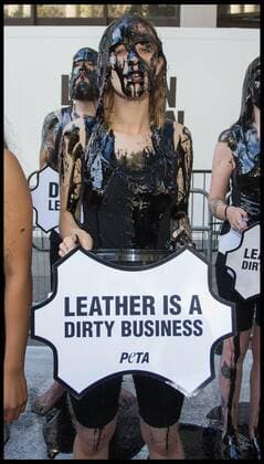 . 13 09 2019. London, United Kingdom. PETA Leather protest at London Fashion Week. PETA supporters pour buckets of black toxic slime over their heads at London Fashion Week to draw attention to the hazardous waste associated with the leather industry. Signs on the buckets read, Leather Is a Dirty Business and Dump Leather .  xMartynxWheatleyx xi-Imagesx IIM-20145-0014