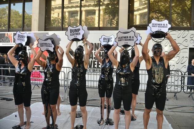 . 13 09 2019. London, United Kingdom. Supporters from animal rights group PETA pour buckets of black toxic slime over their heads to draw attention to the hazardous waste associated with the leather industry, on the opening day of London Fashion Week.  xHowardxJonesx xi-Imagesx IIM-20146-0021