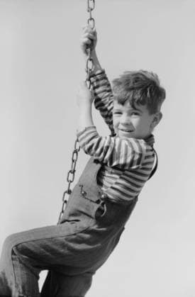 Portrait of Young Boy Hanging on Swing Chain at Playground, Child of Migratory Worker, Weslaco, Texas, USA, Arthur Rothstein for Farm Security Administration, January 1942 Editorial Use Only  Copyright: CircaxImages ghi-circa04733