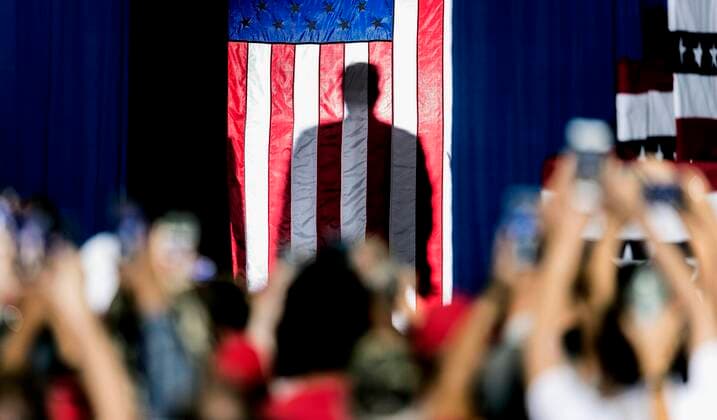 Sept.16, 2019 - Rio Rancho, New Mexico, U.S. - President DONALD TRUMP is seen in shadow behind the American flag as he prepares to make his entrance for a Keep America Great Rally at the Santa Ana Star Center. Rio Rancho U.S. - ZUMAce6_ 20190916_zaf_ce6_001 Copyright: xBrianxCahnx