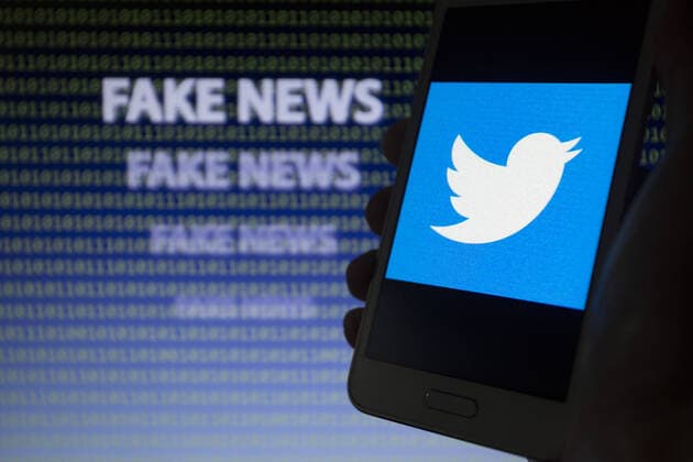 September 20, 2019, Asuncion, Paraguay: Logo icon of Twitter, a microblogging and social networking service, is seen on a smartphone screen against the text fake news and binary code text unfocused on background. Asuncion Paraguay - ZUMAc217 20190920_zip_c217_002 Copyright: xAndrexM.xChangx