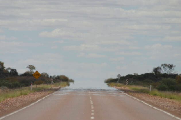 Australia - Heat Haze merges the road. with the sky in outback, near Coober Pedy. South Australia.  Copyright: DonxHadden 10858079