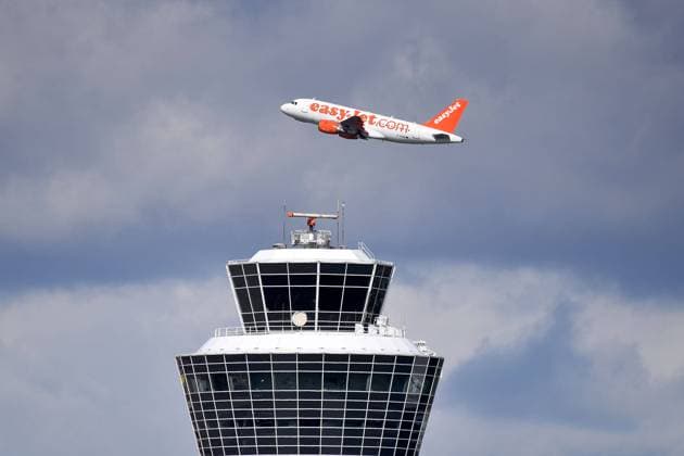EASY JET ,EASYJET passenger aircraft takes off behind the tower, air traffic,fly aviation Franz Josef Strauss airport in Munich Munich Munich