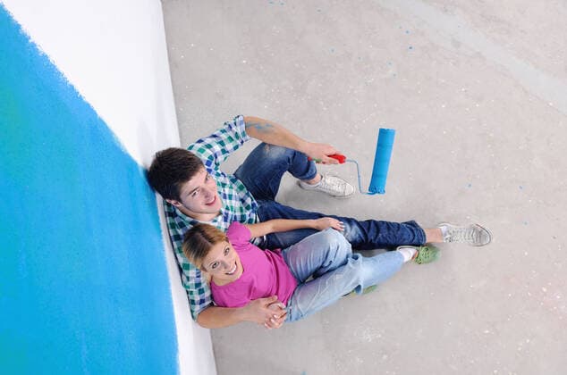 happy young couple relax after painting white wall in green and blue color in their new home,model released, Symbolfoto ING_32193_16248