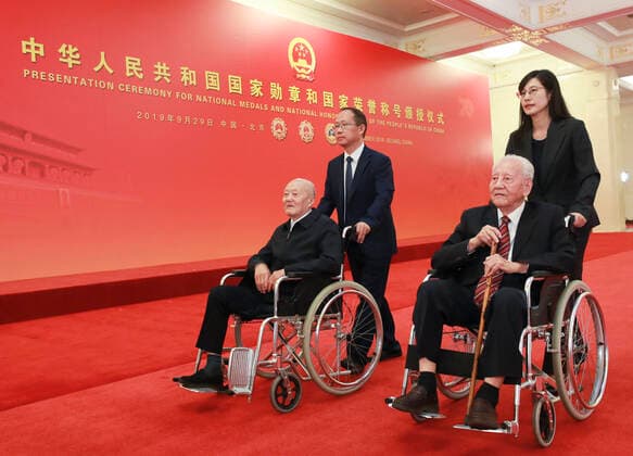 (190929) -- BEIJING, Sept. 29, 2019 -- Awardees of the Medal of the Republic Zhang Fuqing and Huang Xuhua prepare to enter the Golden Hall at the Great Hall of the People in Beijing, capital of China, Sept. 29, 2019. China held the presentation ceremony of the national medals and honorary titles on Sunday at the Great Hall of the People, ahead of the 70th anniversary of the founding of the People s Republic of China (PRC) on Oct. 1. ) CHINA-BEIJING-NATIONAL MEDALS-HONORARY TITLES-PRC FOUNDING-70TH ANNIVERSARY (CN) PangxXinglei 