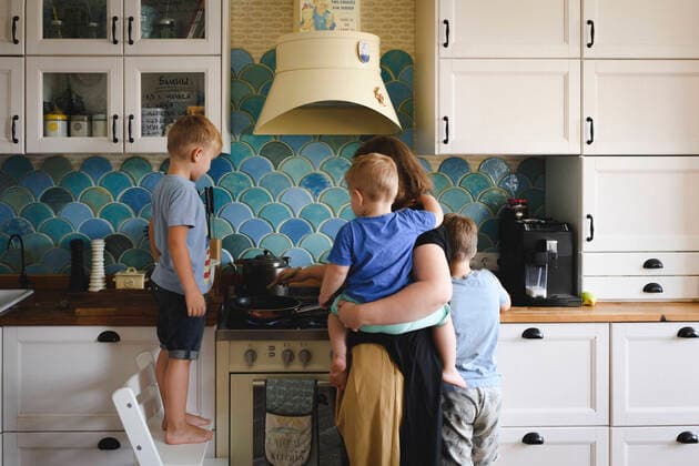Mother cooking with her three sons in the kitchen model released Symbolfoto property released  EYAF00347