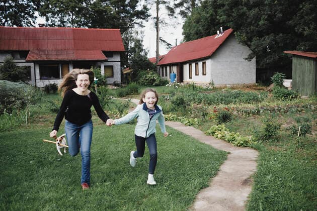 Carefree mother and daughter running in garden model released Symbolfoto property released  KMKF01039